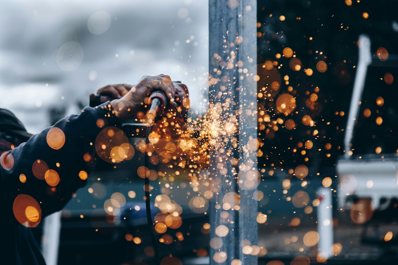 A welder at work with sparks flying