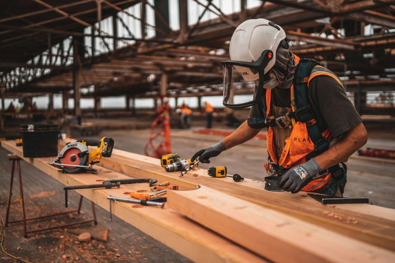 A tradesman cutting timber on a job site