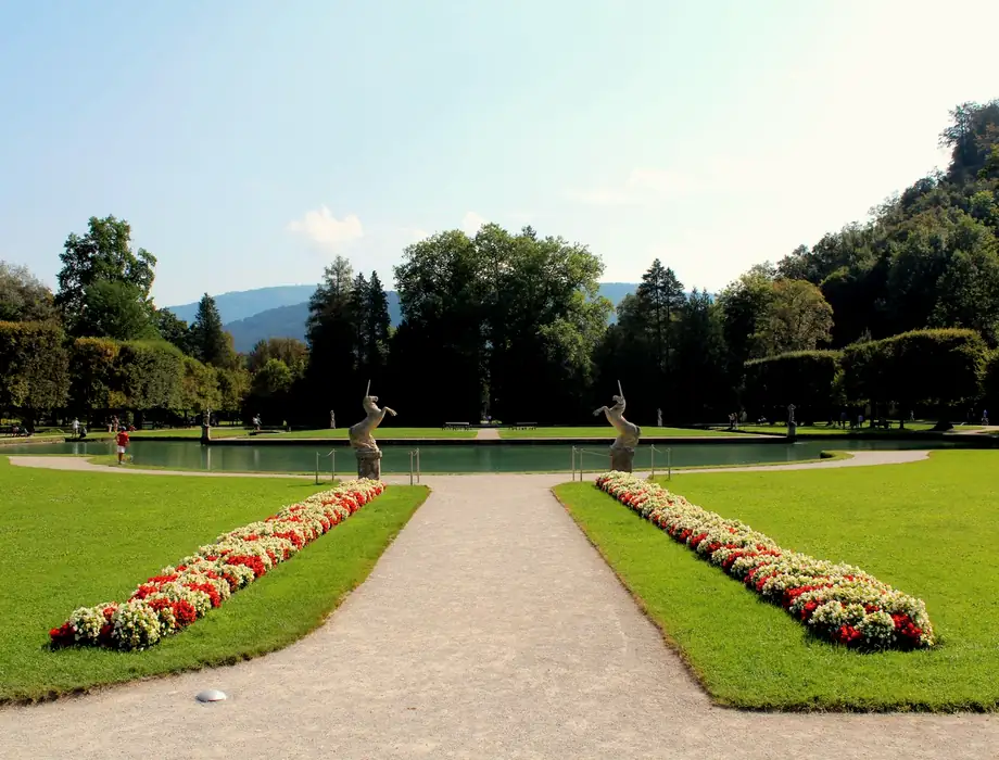 A formal garden with clipped hedges and a path