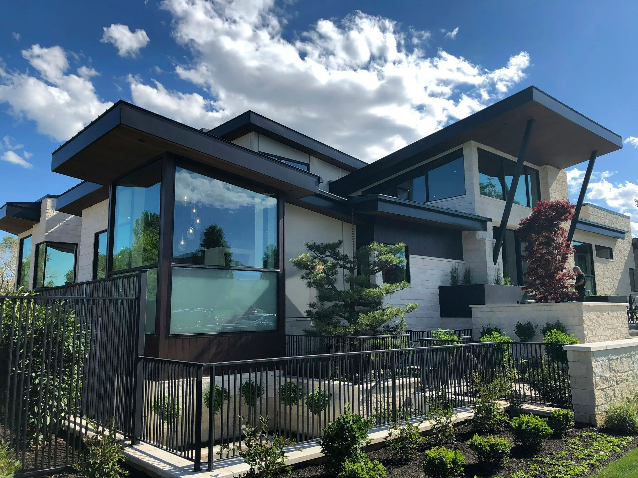 A modern home with dark roofing and expansive glass
