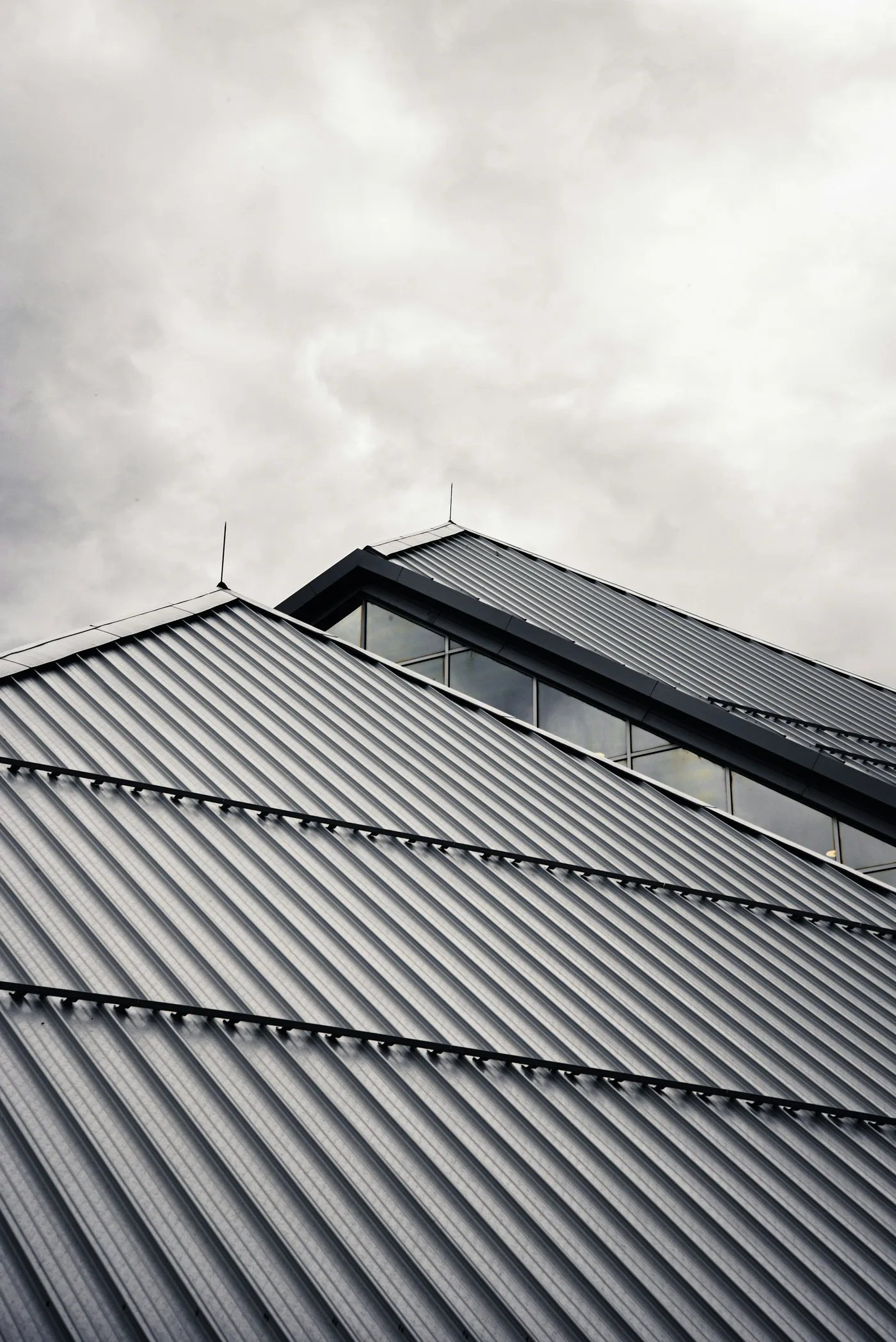 Dark standing-seam ridges running to the eave