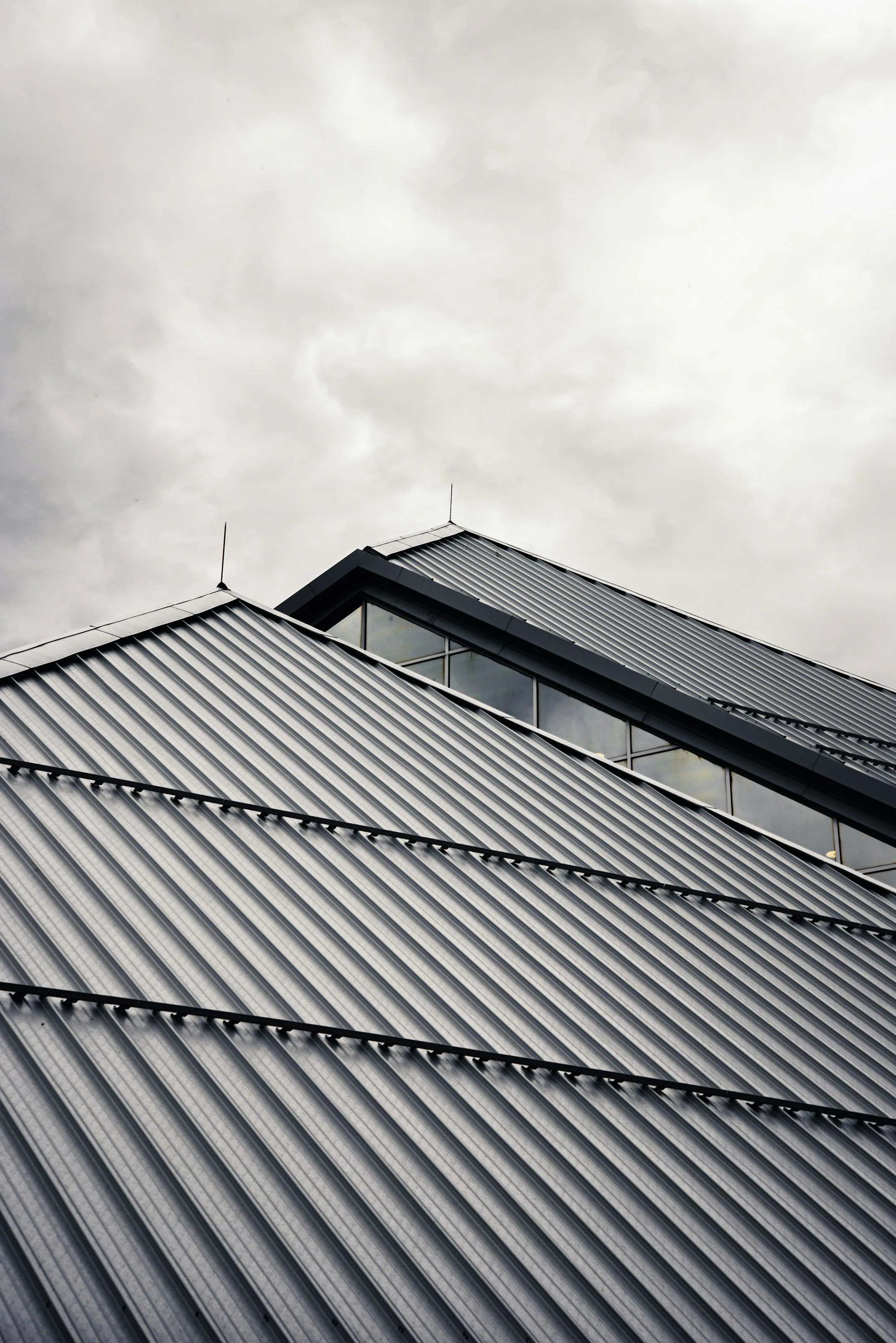 Dark standing-seam ridges running to the eave