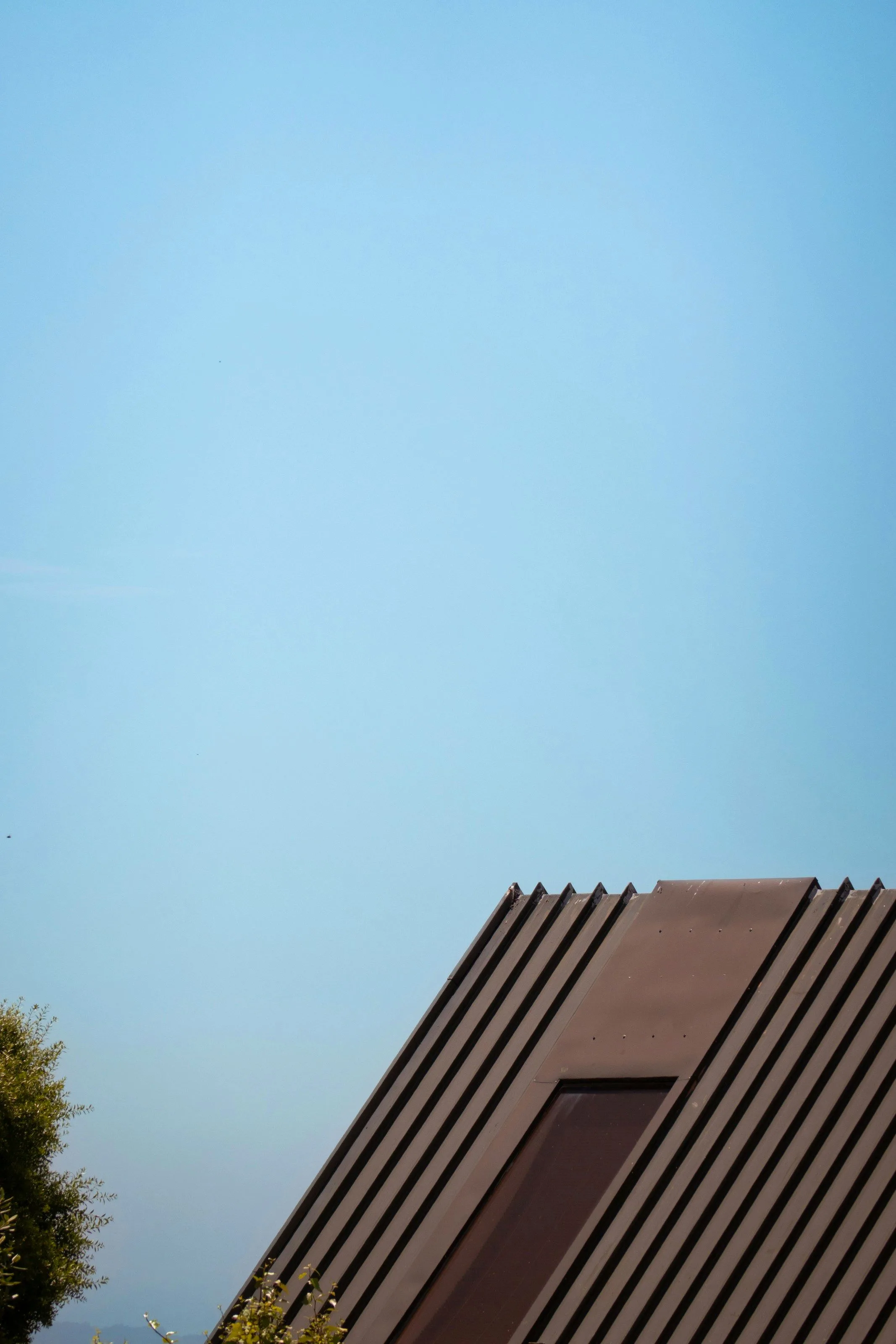 Concept detail: a roof ridge rising against open sky